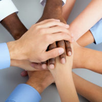International  business team showing unity with their hands together